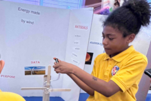 An Indy STEAM Academy student demonstrates her Energy By Wind science project.