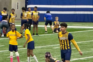 Indy STEAM Dragons soccer team on the field, including girls.