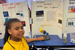 IndySTEAM Academy student presents her solar system science project.